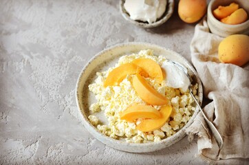 Fresh homemade cottage cheese with sour cream and apricots, breakfast, still life