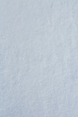 Natural snow texture. Smooth surface of clean fresh snow. Snowy ground. Winter background with snow patterns. Perfect for Christmas and New Year design. Closeup top view.