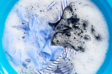 Clothes soak in powder detergent water dissolution. Laundry concept
