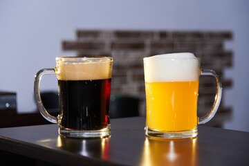 two mugs of dark and light beer on the bar. International beer day. Culture of brewing in a craft beer store