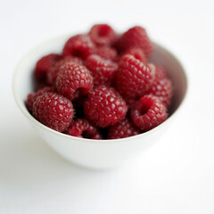 Close up of some raspberries in a bowl