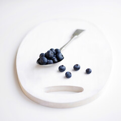 A studio shot of blueberries on a slate