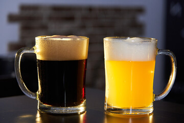 two mugs of dark and light beer on the bar. International beer day. Culture of brewing in a craft beer store