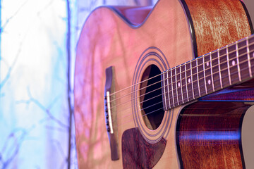 Fototapeta premium Acoustic guitar on a beautiful colored background. The concept of stringed instruments.