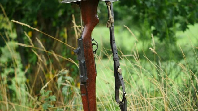 Memorial battlefield cross. Symbol of a fallen US soldier. M1 rifle with helmet.