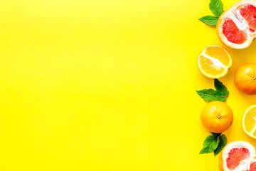 Fototapeta na wymiar Citrus fruits on yellow background top view