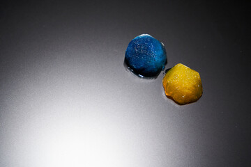 Two pieces of beautiful ice blue and orange on a matte surface with backlight top view