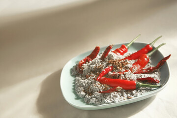 Red chillies and cigarette ashes