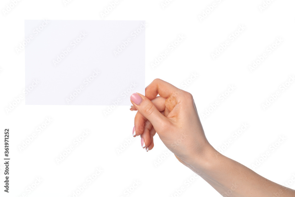 Wall mural Woman's hand holding blank white sheet of paper isolated on white