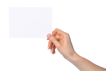 Woman's hand holding blank white sheet of paper isolated on white