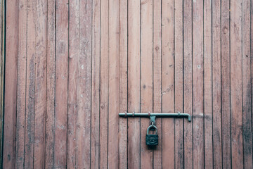 A vintage lock on a antique wooden door.