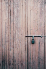 A vintage lock on a antique wooden door.