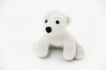 toy polar bear made of felted wool on white background