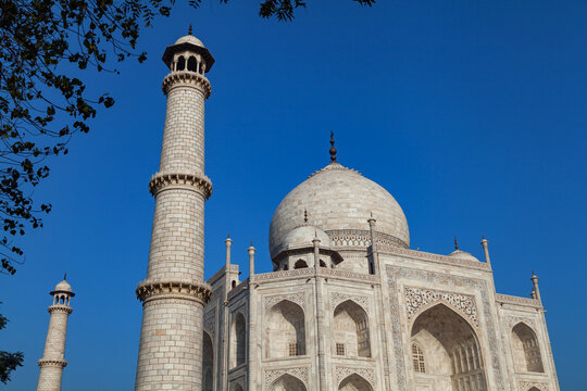 A partail view of the Taj Mahal with two of its minaret and main tomb,