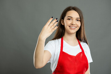 Portrait of female supermarket employee showing number four