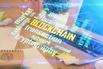 Multi exposure of blockchain theme hologram and table with computer background. Concept of bitcoin crypto currency.