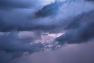 Naklejka na ściany i meble Light in the dark dramatic storm clouds background
