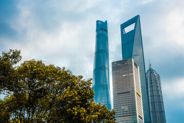 Modern skyscrapers in Lujiazui, the financial district in Shanghai, shot on a cloudy day, at sunset.