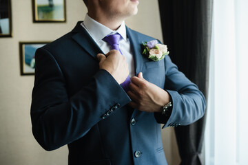 man in a jacket, groom straightens his jacket, groom's fees