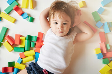 Cute baby girl on toy background