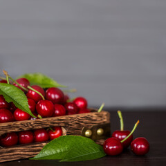 ripe fresh cherries close-up. background with cherries in a wooden box on a wooden background. background with ripe cherries and leaves.