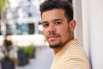 side portrait serious young mixed race african american man with beard