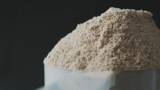 Protein powder in scoop, close up
