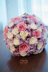the bride's bouquet, bouquet of roses, wedding rings with a bouquet