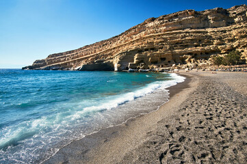 People on the sandy Matala beach on the island of Crete