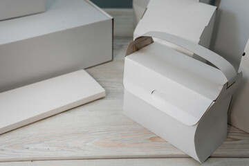 Different design and shape of cardboard boxes, paper containers. The concept of production and development of packaging. Industry. Place for text