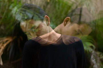 Young Asian man with long hair at the park with multiple exposure effect