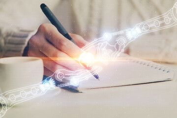 Double exposure of writing hands on background with data solution hologram on front. Technology concept. Close up