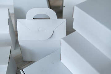 Different design and shape of cardboard boxes, paper containers. The concept of production and development of packaging. Industry. Place for text. selective focus