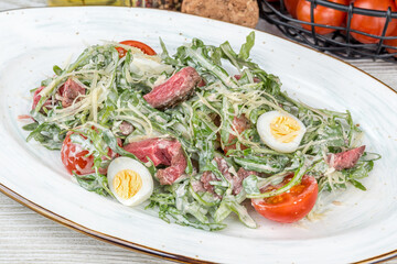 Salad with roast beef, vegetables, egg, fresh herbs.