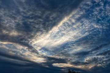 Clouds at sunset. Clouds. Cumulus sunset clouds with sun setting down.