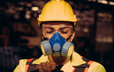 Engineers man wear protective masks to work in the factory.