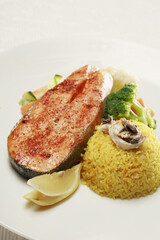 Salmon main course with baked rice and vegetables