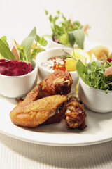 Dish of fried calamari, fried crab balls and fried chicken with salad and dip