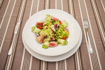 Served delicious food in the restaurant, salads, dishes, meat, sauces. 
