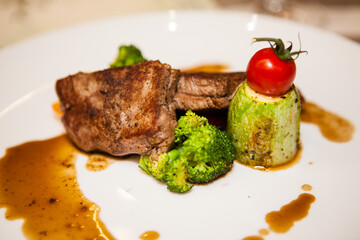 Served delicious food in the restaurant, salads, dishes, meat, sauces. 
