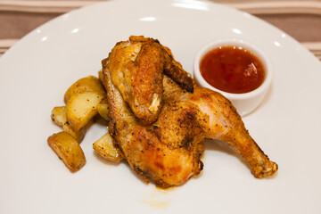 Served delicious food in the restaurant, salads, dishes, meat, sauces. Chicken with a delicious crust with potatoes and sauce. 
