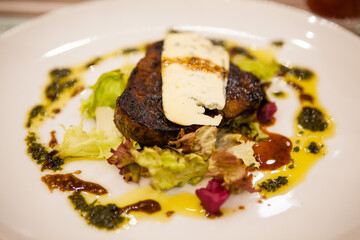 Served delicious food in the restaurant, salads, dishes, meat, sauces. 
