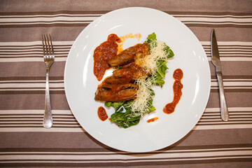 Served delicious food in the restaurant, salads, dishes, meat, sauces. 
