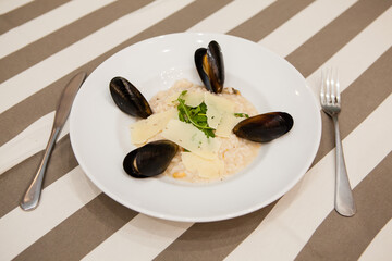Served delicious food in the restaurant, salads, dishes, meat, sauces. mussel soup
