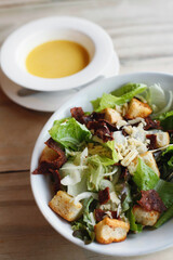 A bowl of salad with croutons