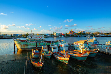 Fishing boats waiting for the rising tide to go fishing in the Gulf of Thailand