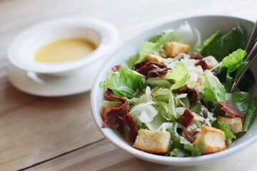 A bowl of salad with croutons