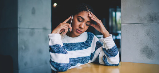 Unhappy hipster girl casual dressed talking about solving problems during serious telephone...