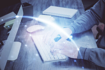 Media network theme hologram with man working on computer on background. Concept of internet...