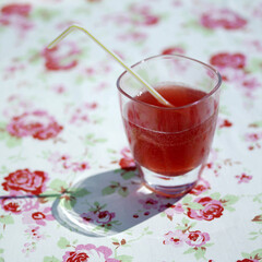 A glass of fizzy drink with drinking straw